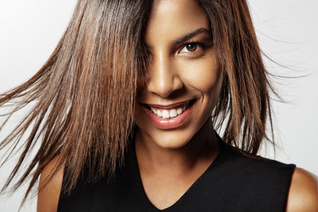 smiling black woman with fluttering hair
